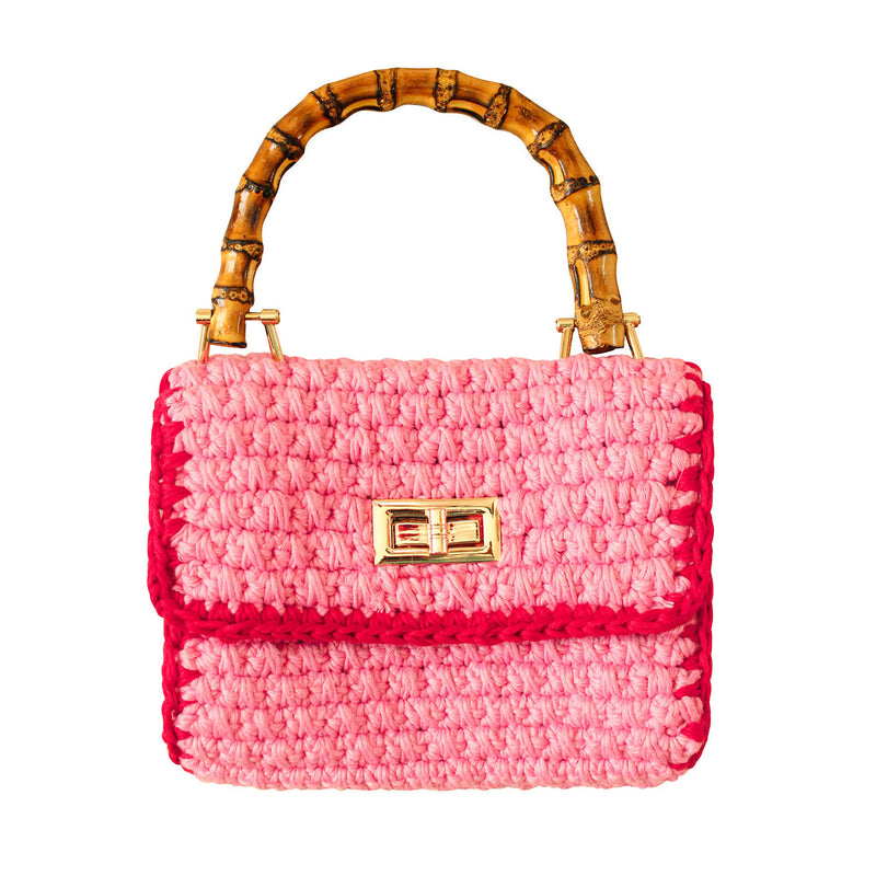 AIRMAIL Crochet bag in pink & red is the petite handbag you never knew you needed. Perfectly sized to fit your essentials for casual soirees.  Made from crocheted cotton yarn and a mini bamboo handle, Airmail bag features a classic duo-tone color. Show yours off with BrunnaCo's dresses and crochet hats. Comes with a crossbody chain strap for those who praise practicality.