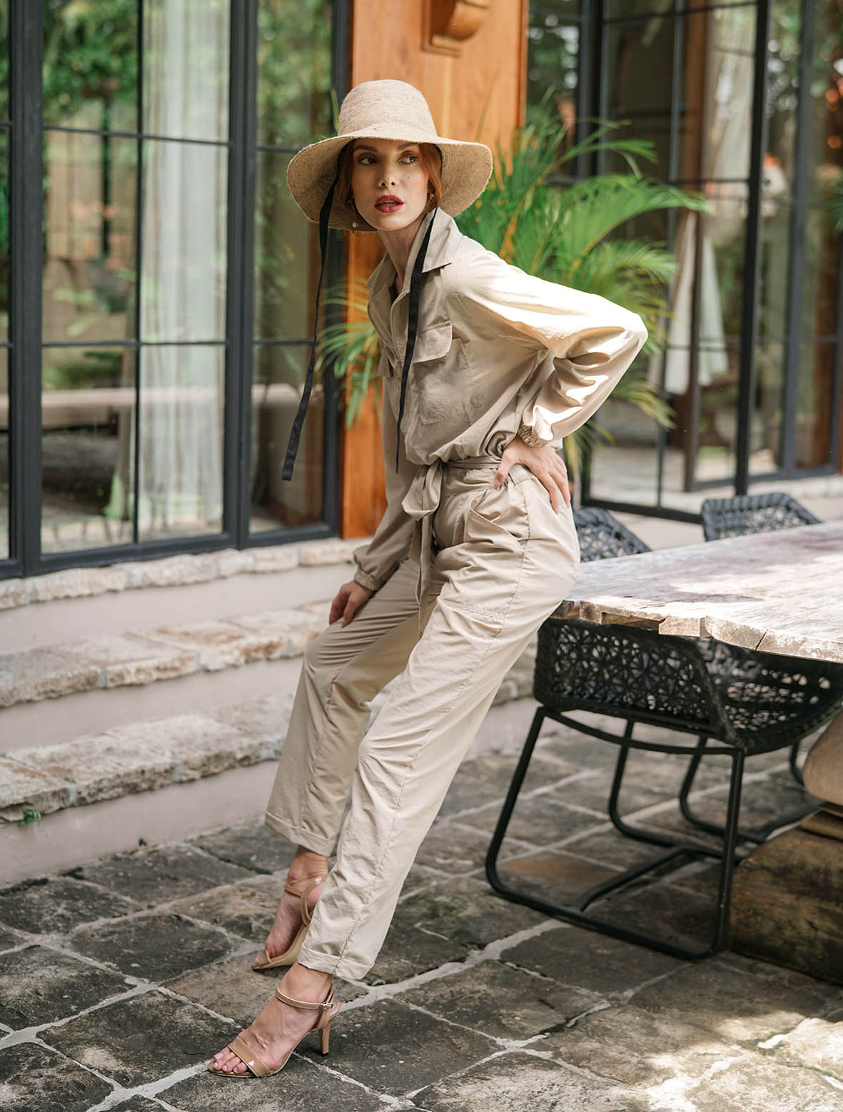 Our cool and casual Amelia Recycled Jumpsuit in sand beige with its relaxed style is designed for the perfect traveling or outdoor vacation. Complete with a spread collar, tie waist, and front utility pockets, this chic jumpsuit offers a simple yet stylish look.