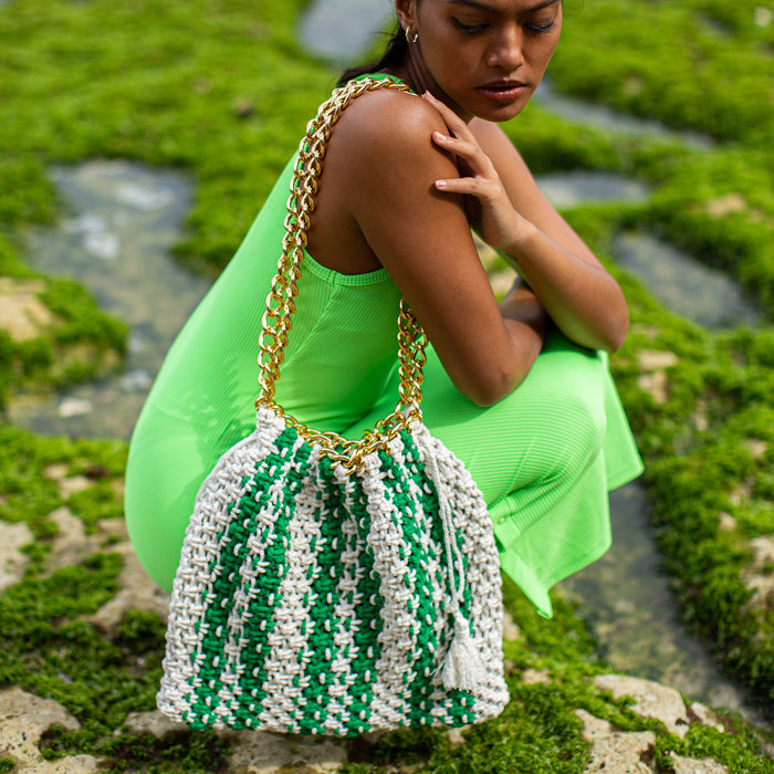 Colette macrame tote bag in Green and White. When Tenniscore meets Beachcore. Ideal for beach holidays, COLETTE has been hand-woven from a durable cotton rope with flattering chain straps and tasseled ties. It’s just the perfect to store all your beach essentials for a carefree island getaway. Wear yours with matching separates for an effortless beach look.