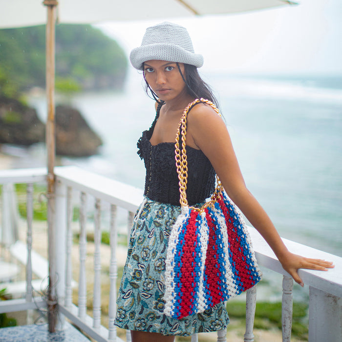 Colette Macrame Beach Tote in Red White and Blue. Ideal for beach holidays, COLETTE has been hand-woven from a durable cotton rope with flattering chain straps and tasseled ties. It’s just the perfect to store all your beach essentials for a care-free island getaway. Wear yours with matching separates for an effortless beach look.