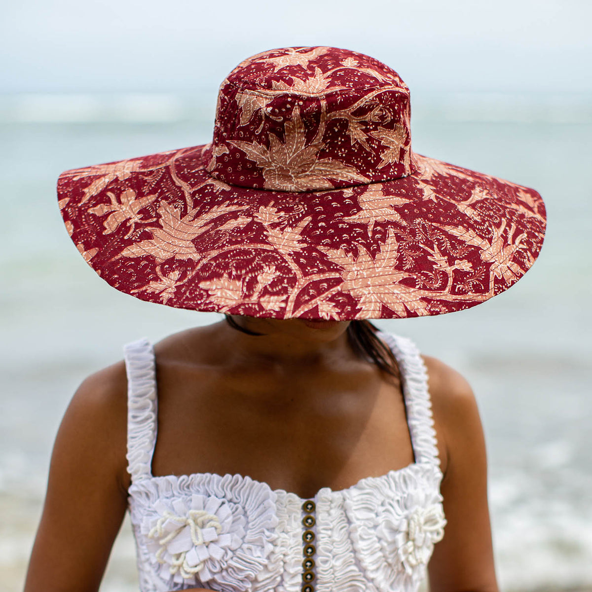 Sustainable Handpainted Javanese Batik Floral Wide-brim Hat For Beach, Pool, and Vacation In Maroon Red and Pink
