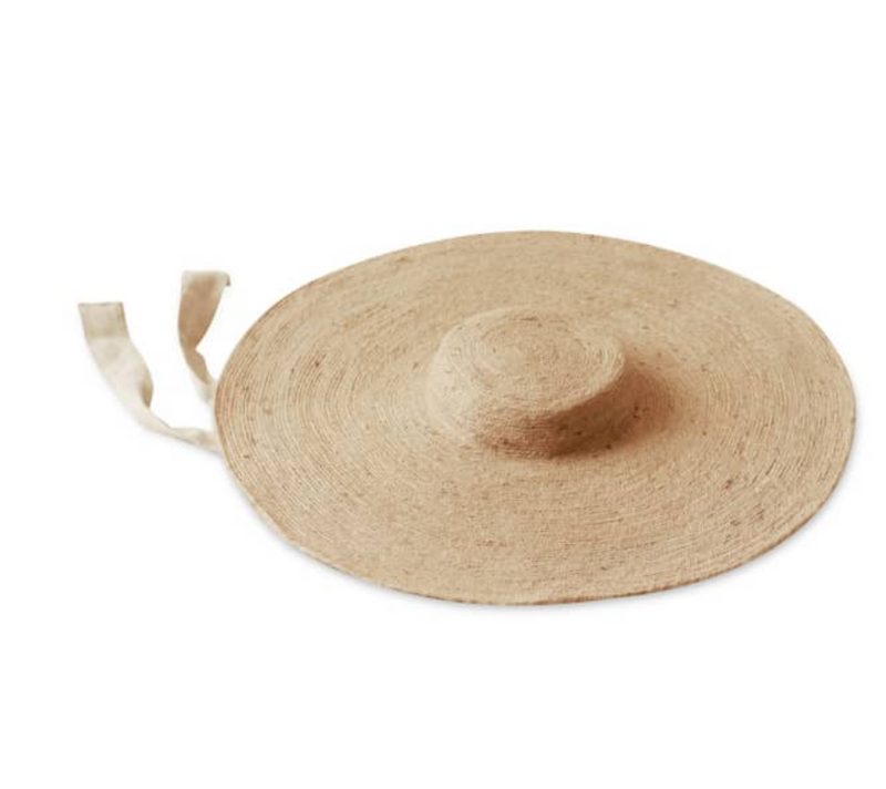 Lola Wide Brim Jute Straw Hat In Natural Beige. This sun hat is hand-weaved meticulously by women artisans in Gianyar, Bali from natural Jute material, this sweet hat offers both comfort and elegance. Designed with ideal thickness and weight that allow its brim to be easily folded, stretched, and styled, making it easy to take to any holiday trip. 