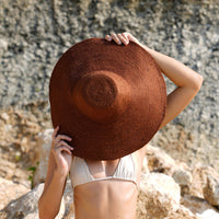 Don't be afraid of the sun. Step out in confidence with this ultra-comfortable Riri Jute woven sun hat in burnt Sienna color. Take this artisanal hat everywhere from the sunny beachside to the hot savanna of your choice and enjoy full-on protection under the sun, while still keeping in style. This sustainable resort vacation straw hat is uniquely made by artisans in Bali.