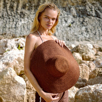 Don't be afraid of the sun. Step out in confidence with this ultra-comfortable Riri Jute woven sun hat in burnt Sienna color. Take this artisanal hat everywhere from the sunny beachside to the hot savanna of your choice and enjoy full-on protection under the sun, while still keeping in style. This sustainable resort vacation straw hat is uniquely made by artisans in Bali.