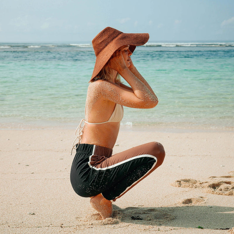 Don't be afraid of the sun. Step out in confidence with this ultra-comfortable Riri Jute woven sun hat in burnt Sienna color. Take this artisanal hat everywhere from the sunny beachside to the hot savanna of your choice and enjoy full-on protection under the sun, while still keeping in style. This sustainable resort vacation straw hat is uniquely made by artisans in Bali.