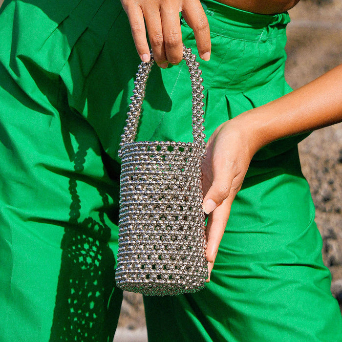 Introducing SILVA, the ultra-desirable bucket bag with the Bali X Cali-infused style. Feel nature’s energy in the palm of your hand as you tote the SILVA Metallic Beads Bucket bag on a sunny day at the beach.&nbsp;The shimmering metallic beads reflect the sunlight, creating a beautiful play of light and color.