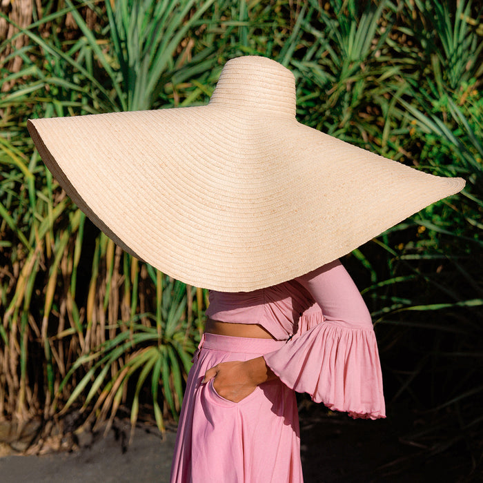 BrunnaCo SOLANA Oversized Straw Hat is a statement piece that will keep the spotlight on you while enjoying the sun. Crafted from braided natural straw, the SOLANA hat has an oversized brim guaranteed to provide full coverage from the sun’s harsh rays. Fold the brim as needed to style.