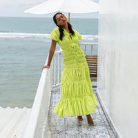 A women wearing elegant long dress by BrunnaCo called SRIKANDI Ruffle Maxi Dress In Lime Green