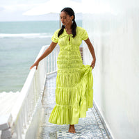 A women wearing elegant long dress by BrunnaCo called SRIKANDI Ruffle Maxi Dress In Lime Green