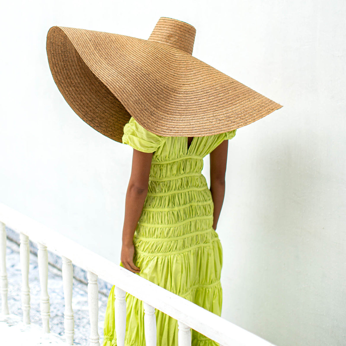 A women wearing elegant long dress by BrunnaCo called SRIKANDI Ruffle Maxi Dress In Lime Green