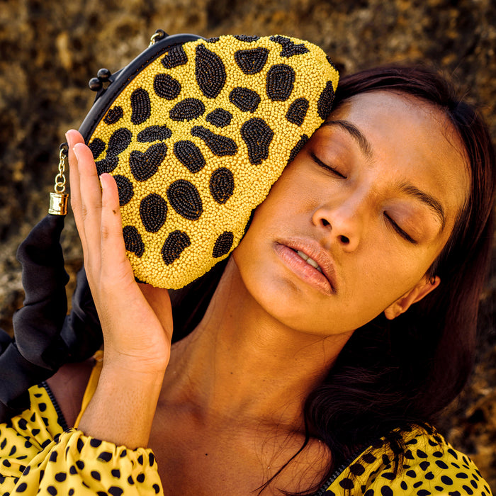 Arnoldi beaded party pola dot clutch bag - Yayoi Kusama inspired dotted pumpkin. Carefully crafted with the best glass beads quality while our artisans bond with their family and kids at home. The beads pattern embodies the iconic Arnoldi flower dots pattern which represents a strong message to embrace our uniqueness.