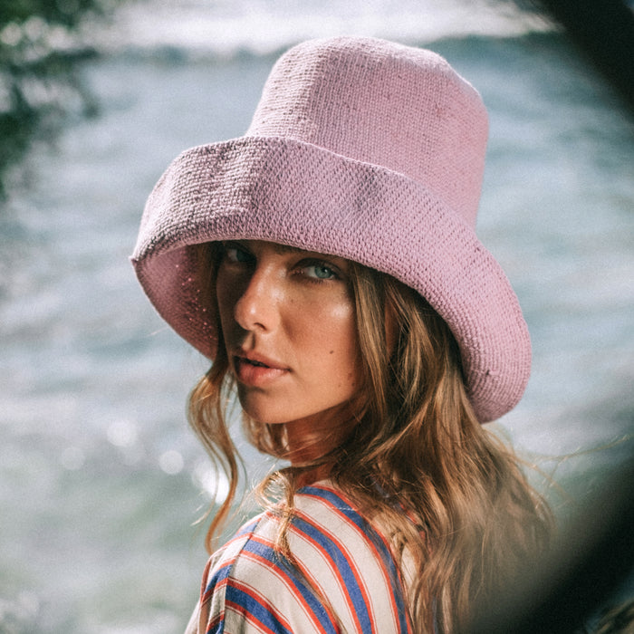 BrunnaCo Bloom Crochet hat in Lilac Purple. Soft and shapeable crochet hat inspired by the classic Calla Lily flower shape. Meticulously made by artisans in the villages of Bali. Its light and semi-floppy construction makes it the perfect hat for picnics at the beach or poolside any season of the year.