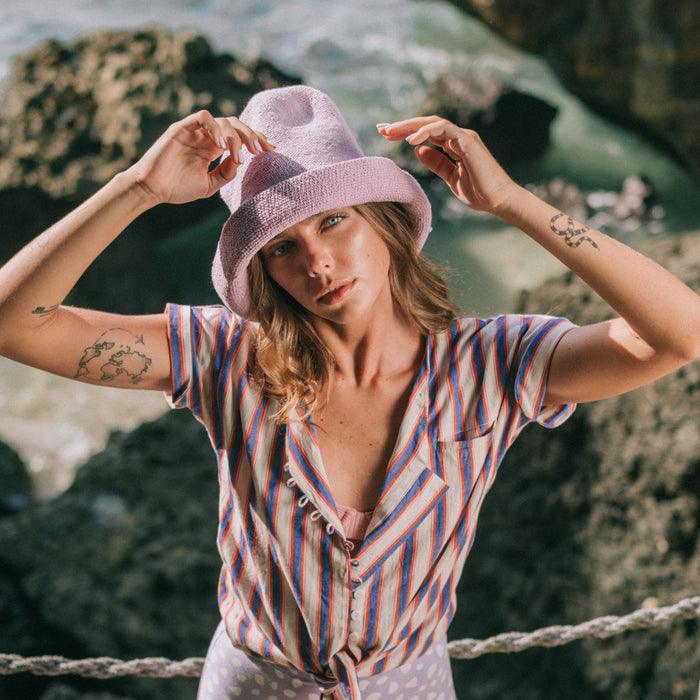 BrunnaCo Bloom Crochet hat in Lilac Purple. Soft and shapeable crochet hat inspired by the classic Calla Lily flower shape. Meticulously made by artisans in the villages of Bali. Its light and semi-floppy construction makes it the perfect hat for picnics at the beach or poolside any season of the year.