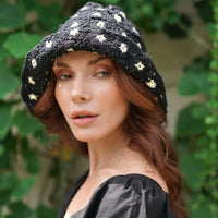 Flora Crochet Hat in Black. This gorgeous crochet hat made from 100% cotton yarn, complete with an eye-catching flower pattern, is designed to give you a fun and feminine fit.  A must-have collection for creating a cute and casual look. Hand-crocheted with love by our female artisans from their very own home in Bali.