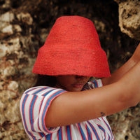 Naomi Jute Bucket Hat in red is designed specifically for the wild at heart with classic sophistication. Enjoy lounging poolside or exploring the city on sun-soaked days as its protective hat brim provides ample shade. Made of natural jute straws which have the perfect weight, this hat will sit comfortably and won't fly away in sudden gusts. It's also very practical to pack in any size luggages and ideal to take on any trips.