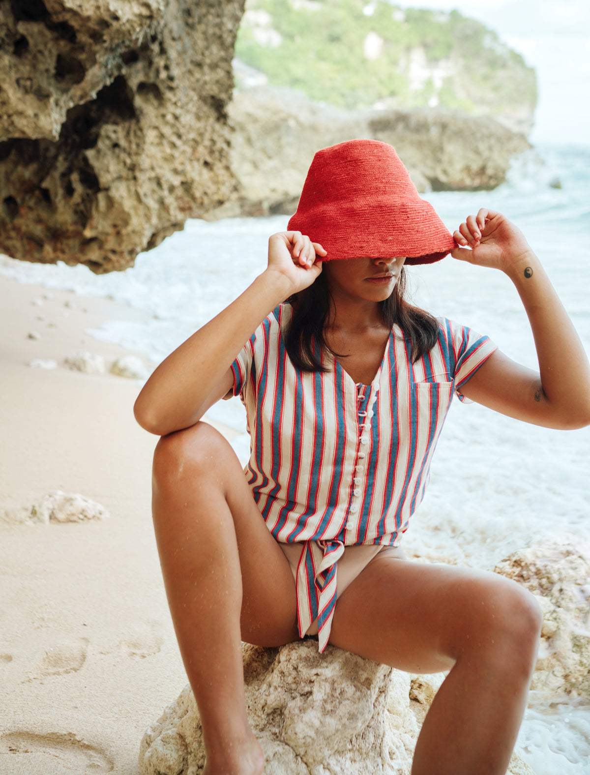 Naomi Jute Bucket Hat in red is designed specifically for the wild at heart with classic sophistication. Enjoy lounging poolside or exploring the city on sun-soaked days as its protective hat brim provides ample shade. Made of natural jute straws which have the perfect weight, this hat will sit comfortably and won't fly away in sudden gusts. It's also very practical to pack in any size luggages and ideal to take on any trips.