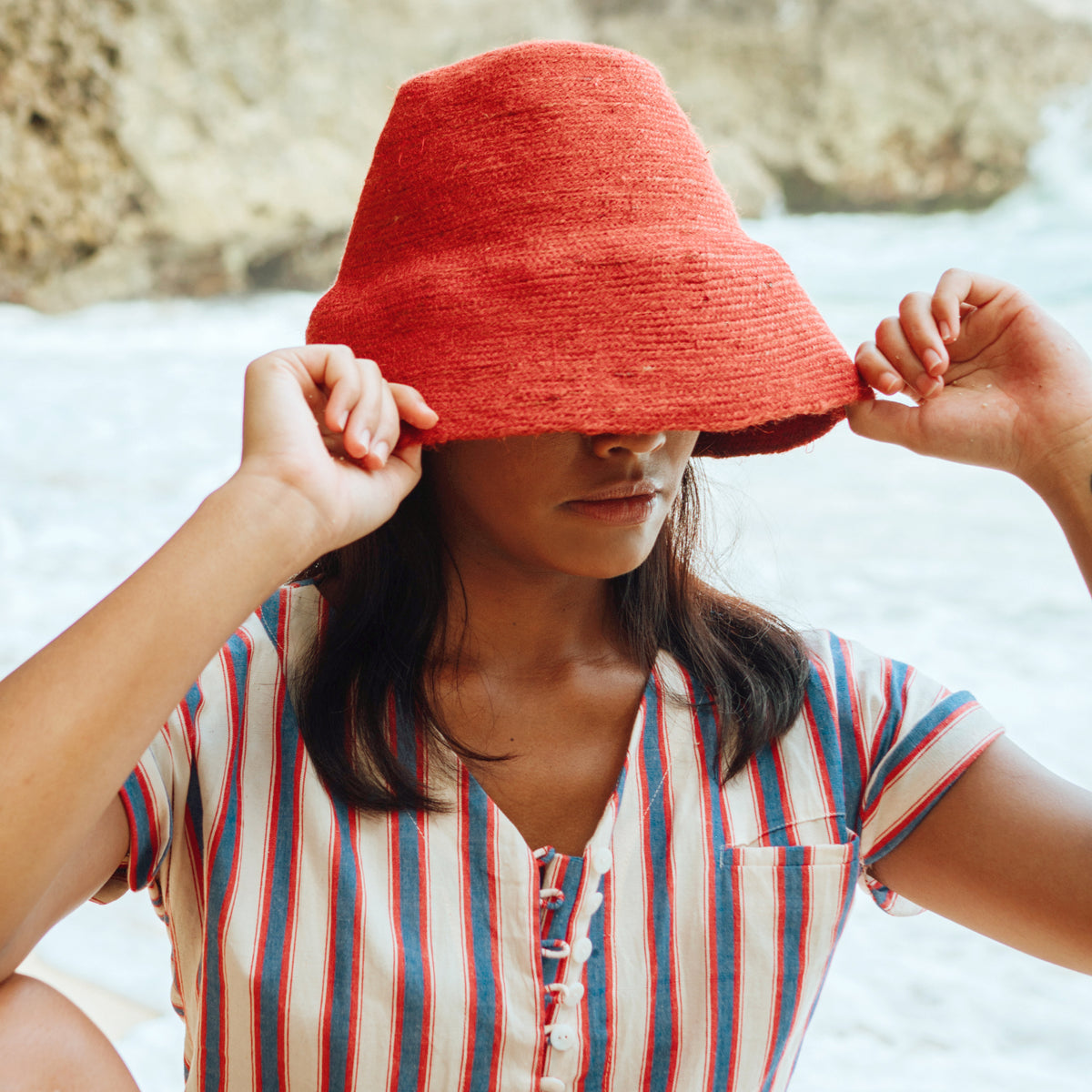 Naomi Jute Bucket Hat in red is designed specifically for the wild at heart with classic sophistication. Enjoy lounging poolside or exploring the city on sun-soaked days as its protective hat brim provides ample shade. Made of natural jute straws which have the perfect weight, this hat will sit comfortably and won't fly away in sudden gusts. It's also very practical to pack in any size luggages and ideal to take on any trips.