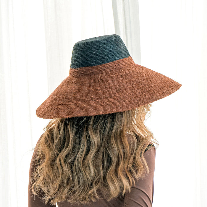 Duo color tone handwoven beach straw hat in Burnt Sienna and Black color, handmade from natural jute straw by local artisan in Bali. Handmade vacation wide-brim hat with domed down brim for maximum sun protection. Sustainably made by female artisan community in Indonesia.