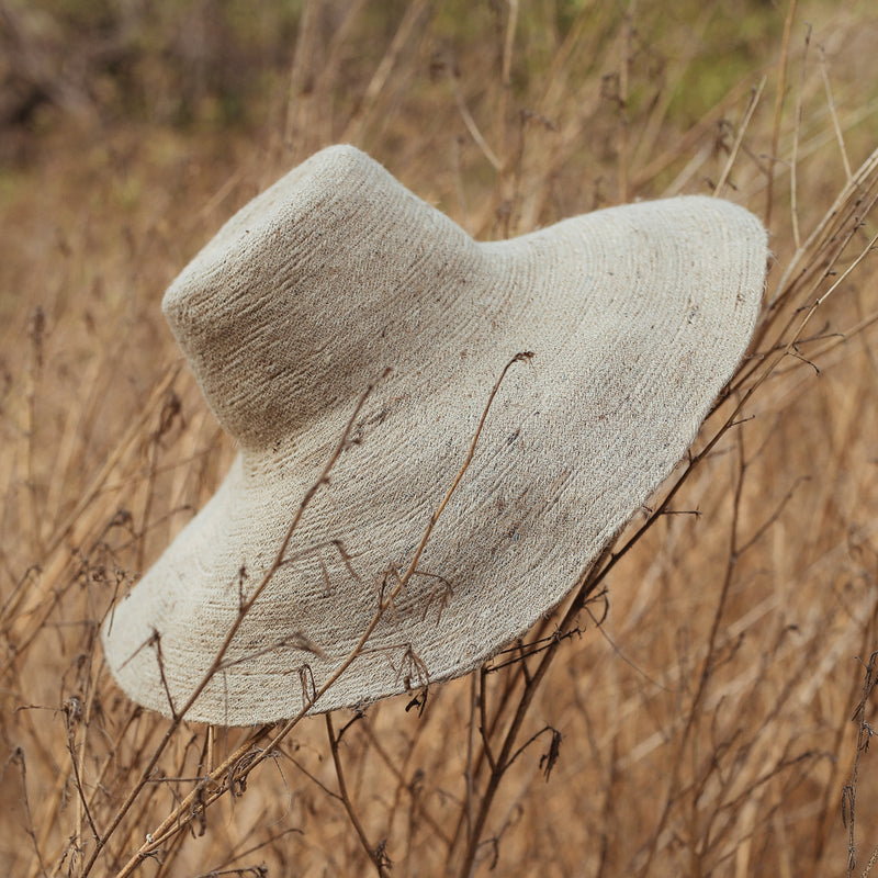 Don't be afraid of the sun. Step out in confidence with this ultra-comfortable Riri Jute woven sun hat in natural beige color. Take this artisanal hat everywhere from the sunny beachside to the hot savanna of your choice and enjoy full-on protection under the sun, while still keeping in style. This sustainable resort vacation straw hat is uniquely made by artisans in Bali.