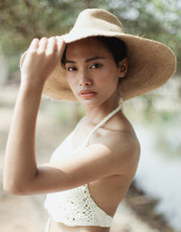 Don't be afraid of the sun. Step out in confidence with this ultra-comfortable Riri Jute woven sun hat in natural beige color. Take this artisanal hat everywhere from the sunny beachside to the hot savanna of your choice and enjoy full-on protection under the sun, while still keeping in style. This sustainable resort vacation straw hat is uniquely made by artisans in Bali.