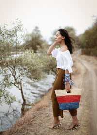 BrunnaCo Sayan Raffia Woven Straw Tote Bag in Red and Blue. A raffia beach tote that is perfect for any beach stroll or a casual walk to the nearest farmer's market