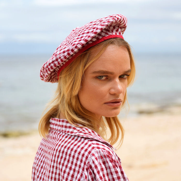 BrunnaCo Simone Beret Gingham Hat in Red, a stylish and sustainable beret hat made from soft gingham cotton with a comfy cotton lining. This 100% vegan and biodegradable hat is perfect for adding a touch of French flair to any outfit.