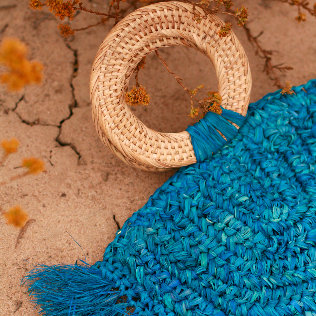 BrunnaCo Beach Raffia halfmoon bag with rattan handle made by artisans in Bali